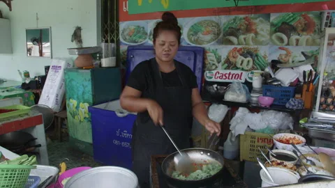Thai Cook adding Vegetables Stock Footage 146235794