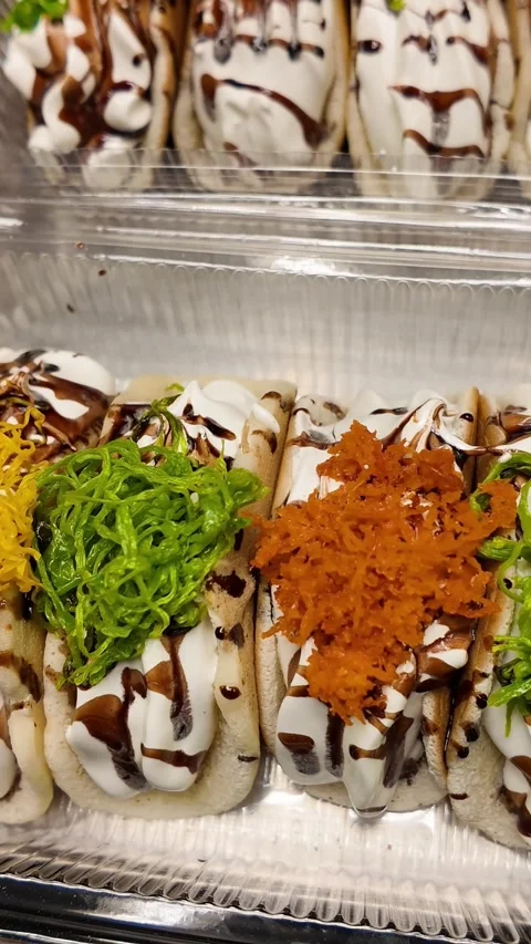 Thai Crispy Crepe Dessert Box with Chocolate Drizzle and Colorful Toppings Video stock 326464490