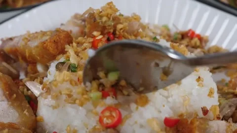 Thai Crispy Pork Belly with Fried Garlic and Chili over Steamed Jasmine Rice Stock Footage 338211978