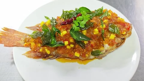 Thai deep-fried ruby fish with sweet chili sauce and crispy basil. Stock-Footage 342394386