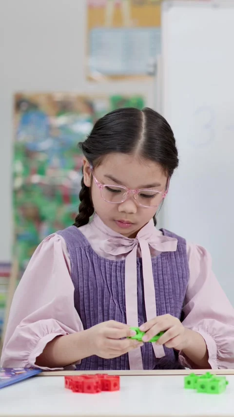 Thai Elementary Student Learning Math with Plastic Counting Blocks in Classroom Vídeos de archivo 334641077