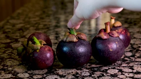 A Thai farmer sprays down containers full of ripe rambutan fruit in Chantaburi Stock Footage 249653550