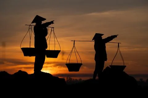Thai farmers are carrying baskets to prepare to go home before the sun goes d Stock Photos