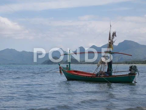 Thai Fishing Boat With Mountains Beyond