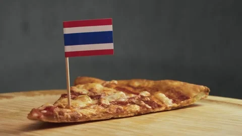 Thai flag in edge of cheese pizza slice, symbol of Thai style pizza using local Stock Footage 323457531