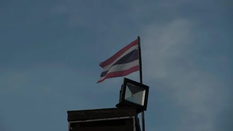 Thai Flag Waves Atop Building Against Cloudy Sky Stock-Footage 307683359
