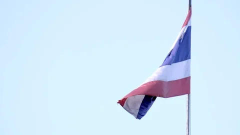 Thai flag waving againct a blue sky in slow motion . Stock Footage