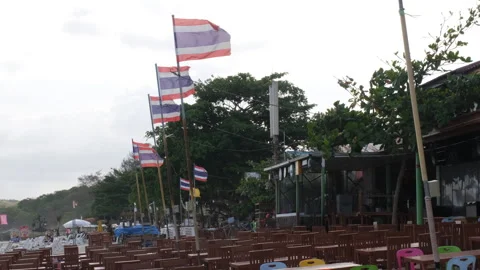 Thai flags and cafe tables on beach Vídeos de archivo 332845798