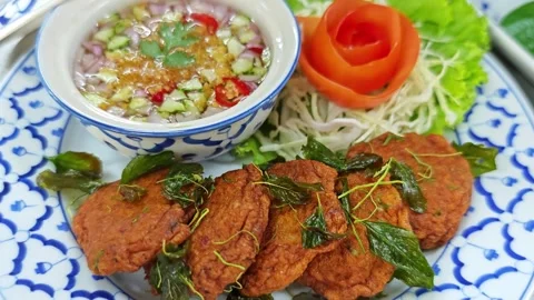 Thai fried fish cakes served with sweet cucumber dipping sauce. Stock Footage 342394592