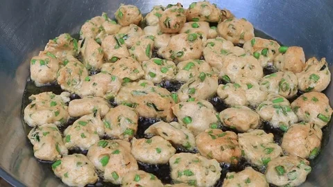 Thai fried fish-paste balls with hot oil in big pan, Thai street food. Stock Footage 82290352