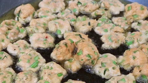 Thai fried fish-paste balls with hot oil in big pan, Thai street food. Stock Footage 82290353