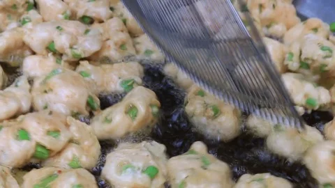 Thai fried fish-paste balls with hot oil in big pan, Thai street food. Stock Footage 82290367