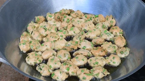 Thai fried fish-paste balls with hot oil in big pan, Thai street food. Stock Footage 82290420