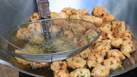 Thai fried fish-paste balls with hot oil in big pan, Thai street food. Stock Footage 82290996