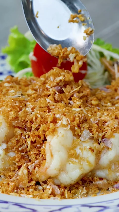 Thai Fried Shrimp with Crispy Garlic Topping on Blue Patterned Plate Stock Footage 338421076