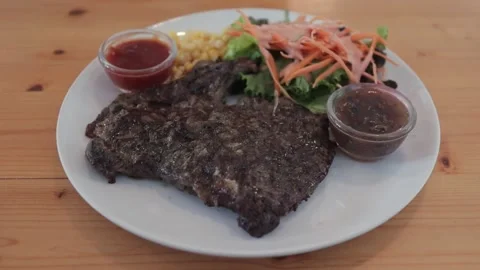 Thai Grass Fed Organic Ribeye Beef Steak, Vegetable Salad With Dressing Sauce Stock Footage 229600345