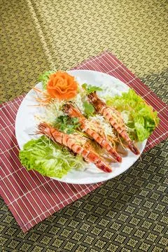 Thai grilled prawns with cabbage lettuce and carrot garnish Stock Photos