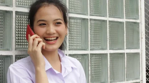 Thai high school student uniform teen beautiful girl calling smart phone Stock Footage 68335344