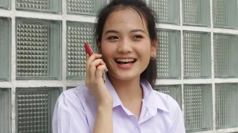 Thai high school student uniform teen beautiful girl calling smart phone Stock Footage 68335424
