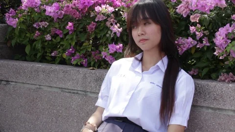 Thai high school student uniform teen beautiful girl calling smart phone Stock Footage 70609332