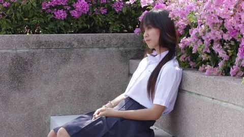 Thai high school student uniform teen beautiful girl calling smart phone Stock Footage 70609872