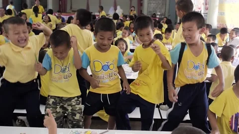 Thai little students dancing in classroom funny cute kids full of joy happiness Stock Footage 157701011