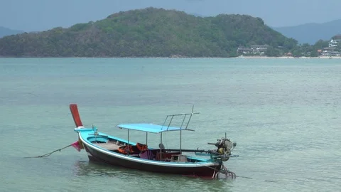 Thai Longtail Boat passing wait Tourists in the Sea on Tropical Beach Stock Footage 107452858