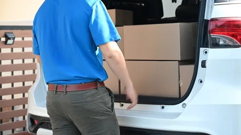 Thai mailman checking parcel and mail boxes for home delivery. Stock Footage 122794527