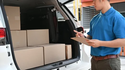 Thai mailman checking parcel and mail boxes for home delivery. Stock Footage 122794532