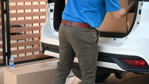 Thai mailman checking parcel and mail boxes for home delivery. Stock Footage 123709144