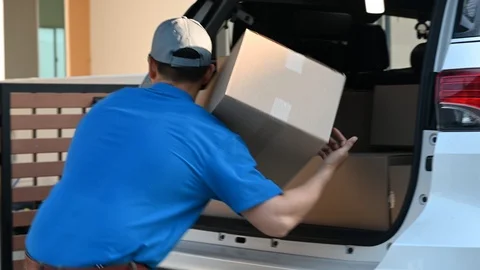 Thai mailman checking parcel and mail boxes for home delivery. Stock Footage 123886447