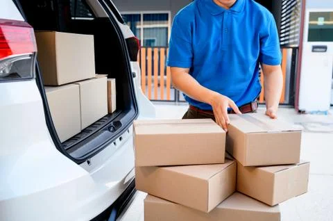 Thai mailman checking parcel and mail boxes for home delivery. Stock Photos