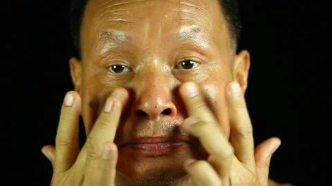 Thai man applying  his face by face cream , in studio  Chiangmai  Thailand Stock Footage 134853019
