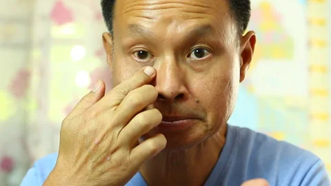 Thai man applying  his face by face cream , in studio  Chiangmai  Thailand Stock Footage 135435398