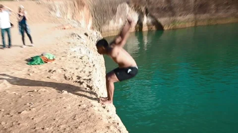 Thai man doing back flip off quarry cliff Stock-Footage 54953812