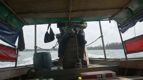 Thai man drives a long-tail boat using handmade steering of outboard motor Stock Footage 69786660