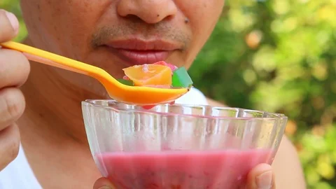 Thai man eating mixed ice desert  in the garden, Chiangmai Thailand Stock Footage 124534559