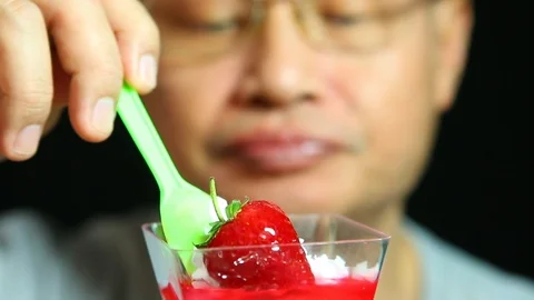 Thai man eating pudding, close up in studio Stock Footage 102693302
