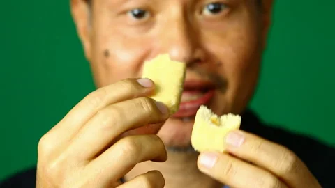 Thai man is eating rice cracker, in studio Chiangmai  Thailand. Stock Footage 168954887