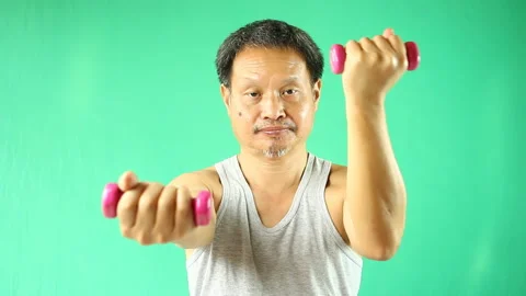 Thai man is  exercising with dumbbell, in studio Chiangmai Thailand. Stock Footage 233770832