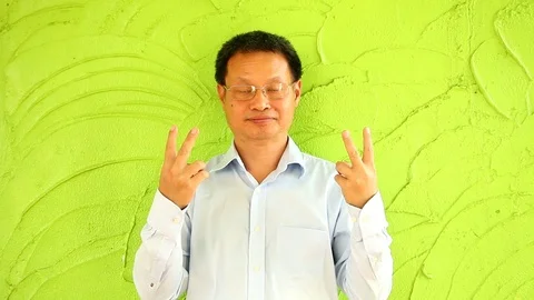 Thai man with green wall Stock-Footage 86093402