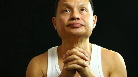 Thai man praying  with black background, in studio   Chiangmai Thailand Stock Footage 147379271