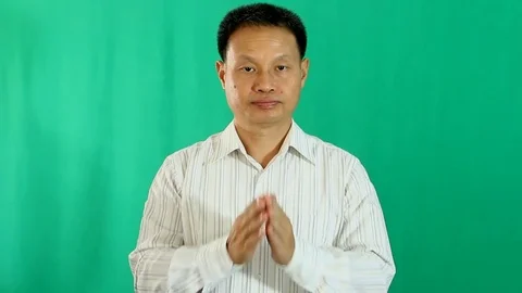 Thai man praying   on green background Stock Footage 83377224
