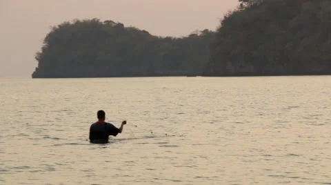 Thai man setting nets before low tide in Ao Nang, Thailand Stock Footage 51025894
