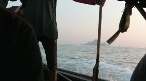 Thai man steers a long-tail boat in Ao Nang, Thailand Stock Footage 51016710