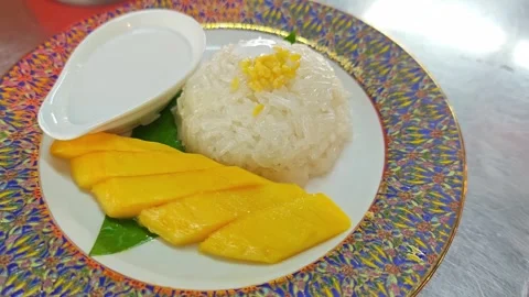 Thai mango sticky rice dessert served on a luxury Benjarong plate. Stock Footage 342404105