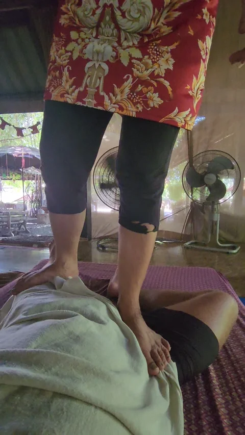 Thai massage in Phuket. A man receiving a massage at a cheap massage parlor Stock Footage 323258077