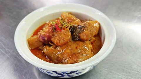 Thai Massaman chicken curry served in a white ceramic bowl. Stockbeeldmateriaal 344658409