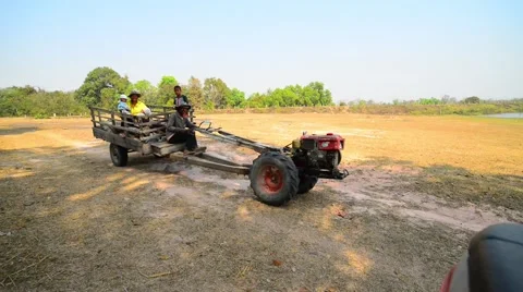 Thai men driving a strange small tractor in Ubon Ratchatan, Thailand Stock Footage 58938388