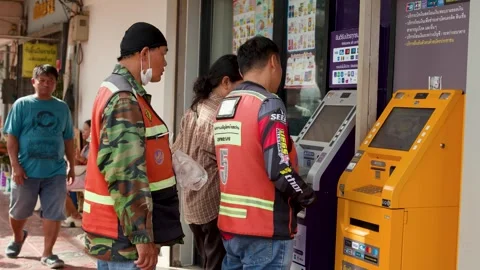 Thai Men in Safety Vests Using Outdoor Banking Kiosks Video stock 339065358